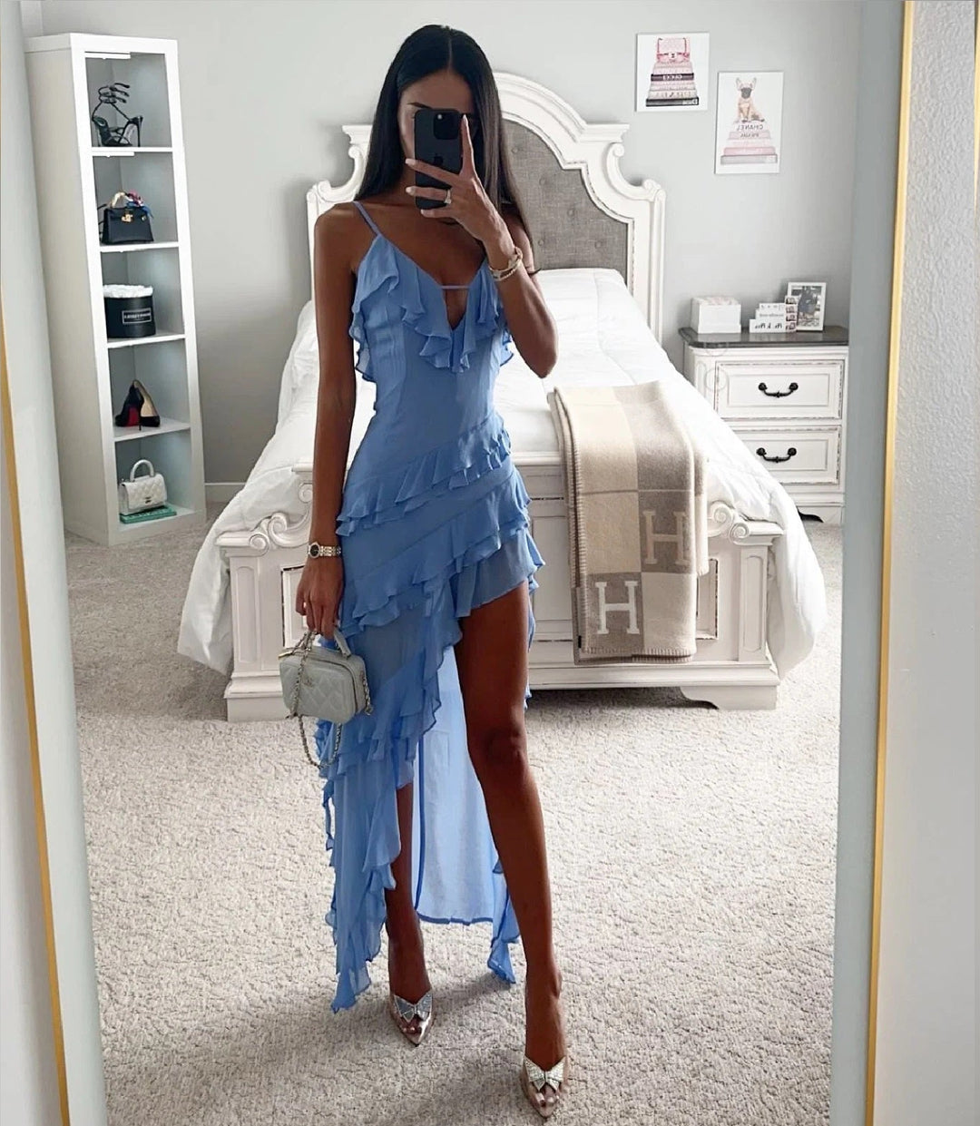 Chic women's blue wrap dress featuring ruffles and an asymmetric high-low hem. Ideal for wedding guests.