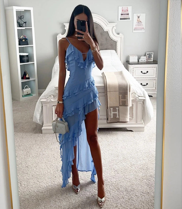 Chic women's blue wrap dress featuring ruffles and an asymmetric high-low hem. Ideal for wedding guests.