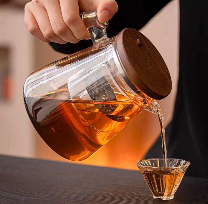 Heat-resistant glass teapot with infuser, perfect for brewing loose leaf tea. Elegant kitchenware for tea lovers.
