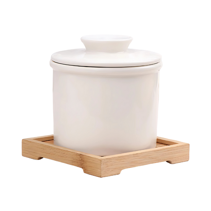 "Elegant ceramic butter keeper with water-sealed system in sleek black, light blue, and white, perfect for kitchen décor."