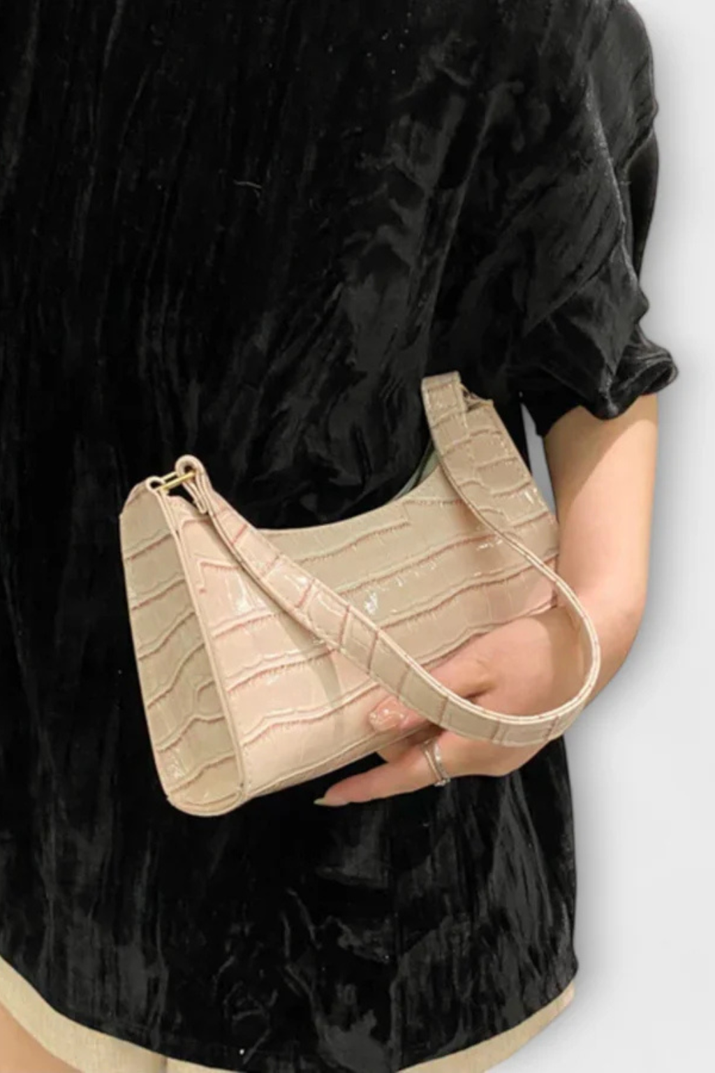 Black classic textured women's handbag, a stylish and compact fashion accessory.