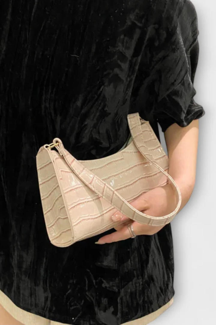 Black classic textured women's handbag, a stylish and compact fashion accessory.