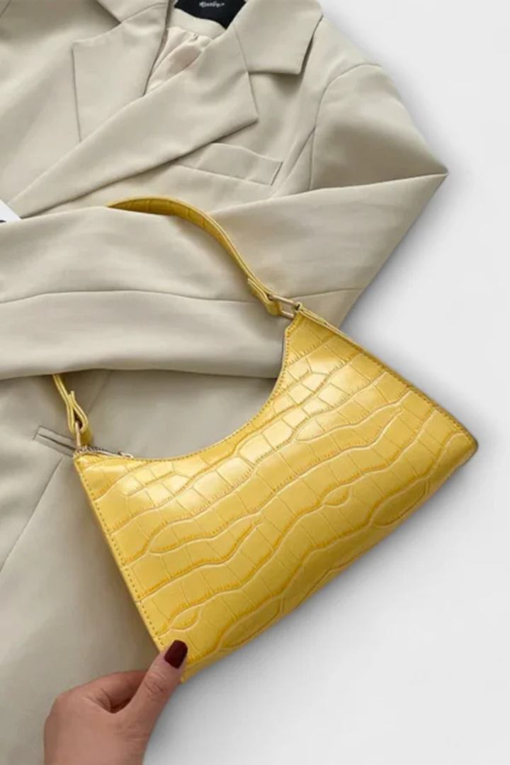 Beige elegant textured compact shoulder bag, ideal for versatile styling.