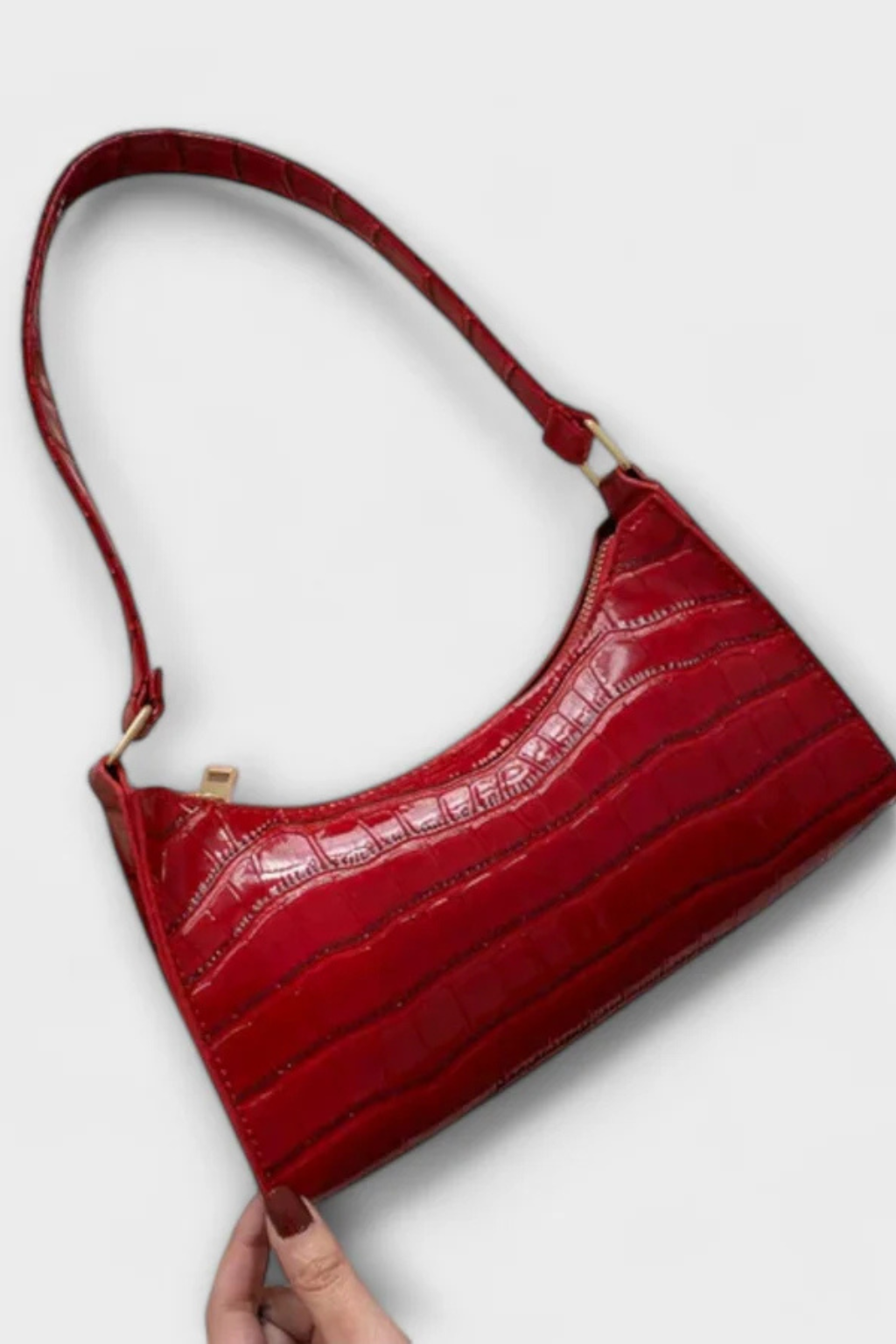 Red elegant textured shoulder bag, a bold and timeless women's accessory.