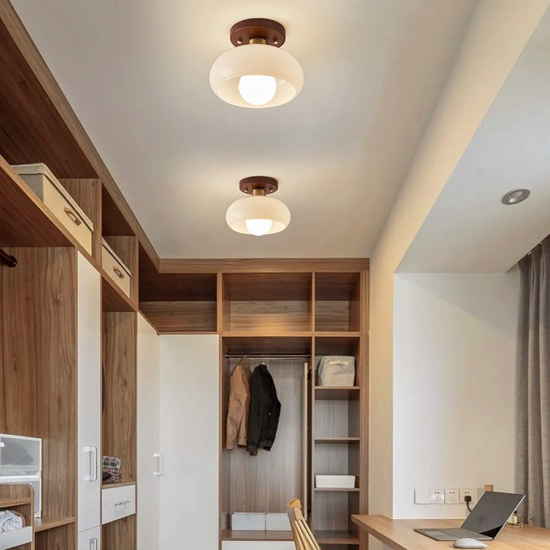 Modern Bauhaus ceiling fixture with elegant wooden accent, providing stylish overhead illumination.