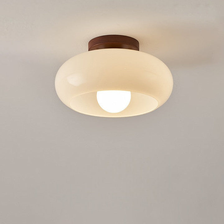 French Bauhaus ceiling lamp featuring a wooden detail, creating a warm, elegant atmospheric light.