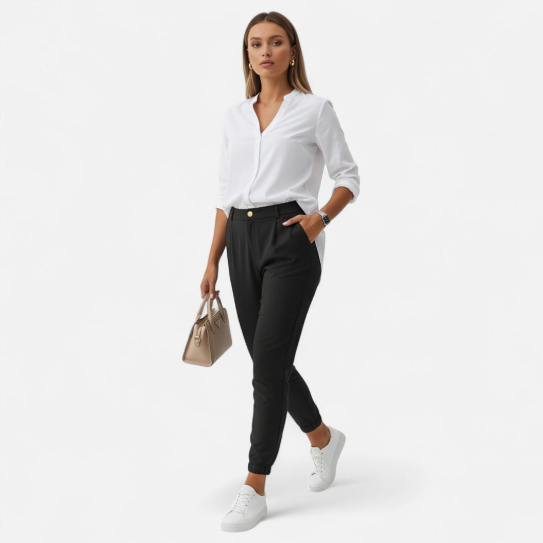 Woman in tailored high-waist slim-fit trousers & blouse, perfect for professional office attire.