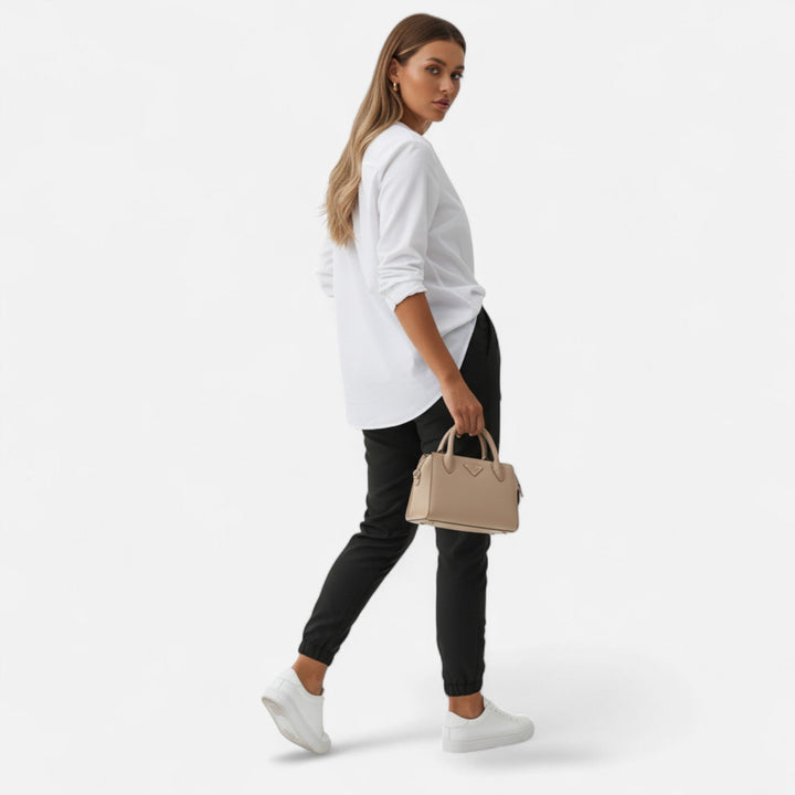 Woman models high-waist slim-fit trousers for a casual chic look, versatile everyday fashion.