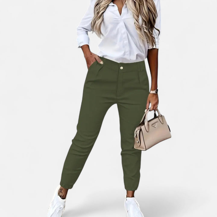 Side view: flattering high-waist slim-fit women's trousers, emphasizing modern design & silhouette.