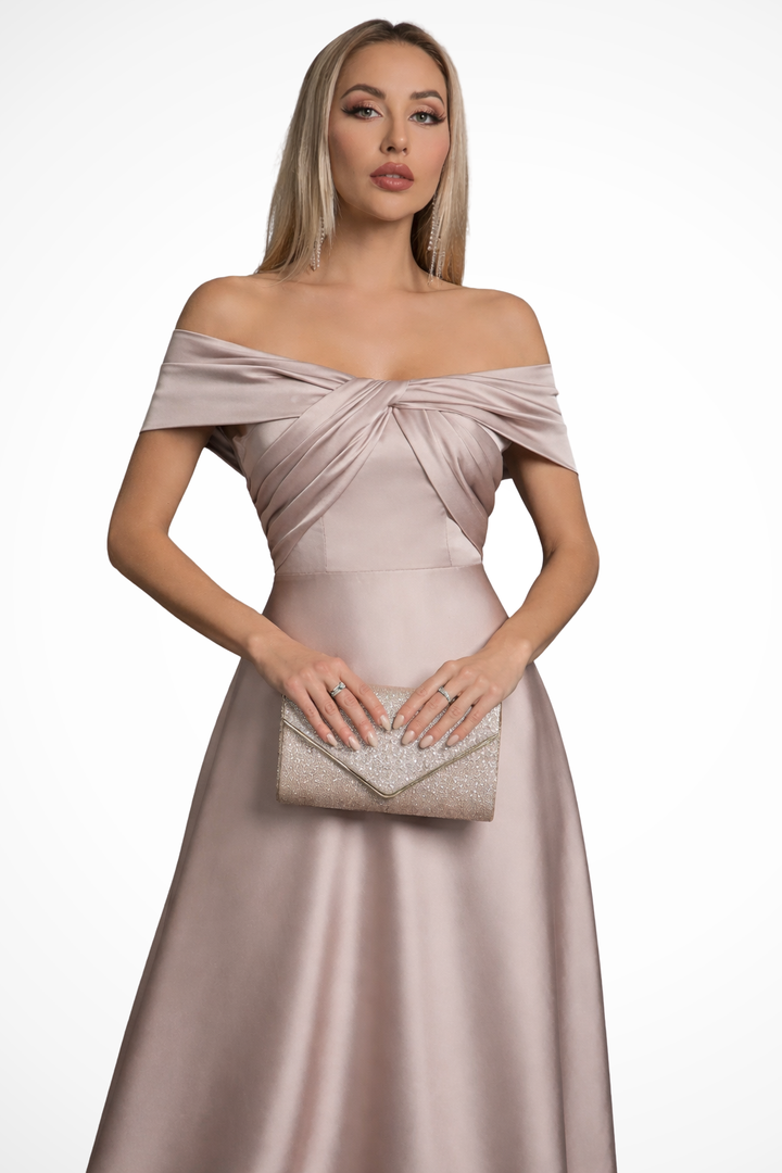 Flowy pleated maxi dress with an elegant off-shoulder and twisted knot design.