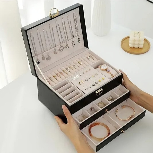 Women's luxury jewelry box featuring multi-tier design, smooth drawers & secure lock for valuables.