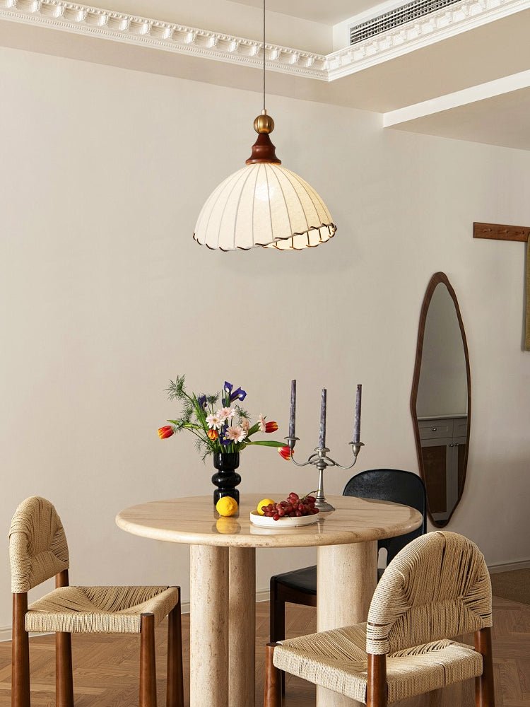 Elegant pendant light with pleated fabric shade, gold-finished top, and wood accent; perfect for modern interiors.