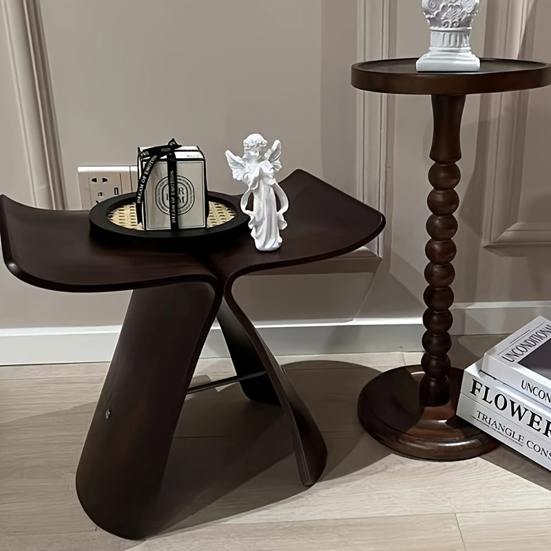 Small, elegant solid wood butterfly stool, perfect for compact modern spaces, versatile home decor.