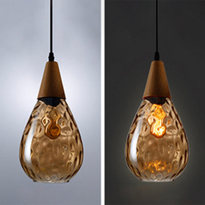 "Elegant teardrop glass pendant light with wood accents, available in clear, golden, smoky gray, perfect for any home decor."