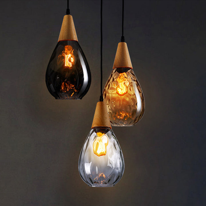 "Elegant teardrop glass pendant light with wood accents, available in clear, golden, smoky gray, perfect for any home decor."