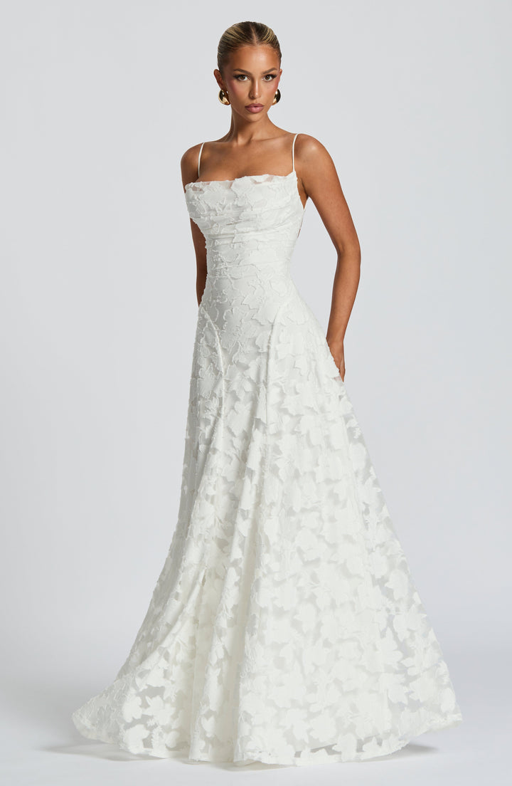 Formal women's evening gown: backless, spaghetti strap maxi dress, ideal for summer occasions.