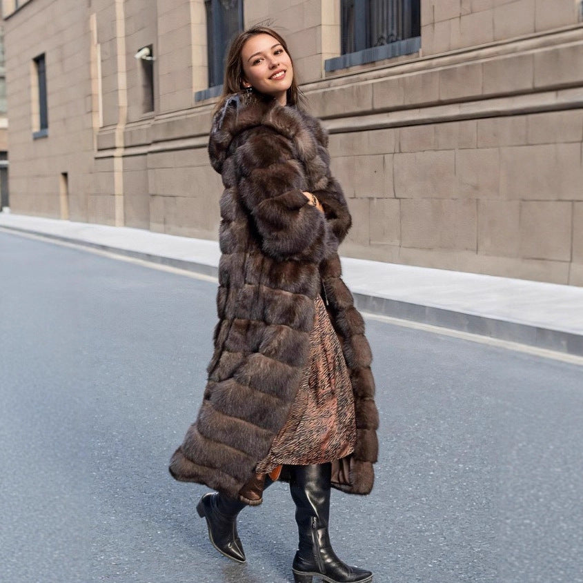 Stylish women's brown faux fur hooded coat, providing luxurious warmth and an elegant look for winter fashion.