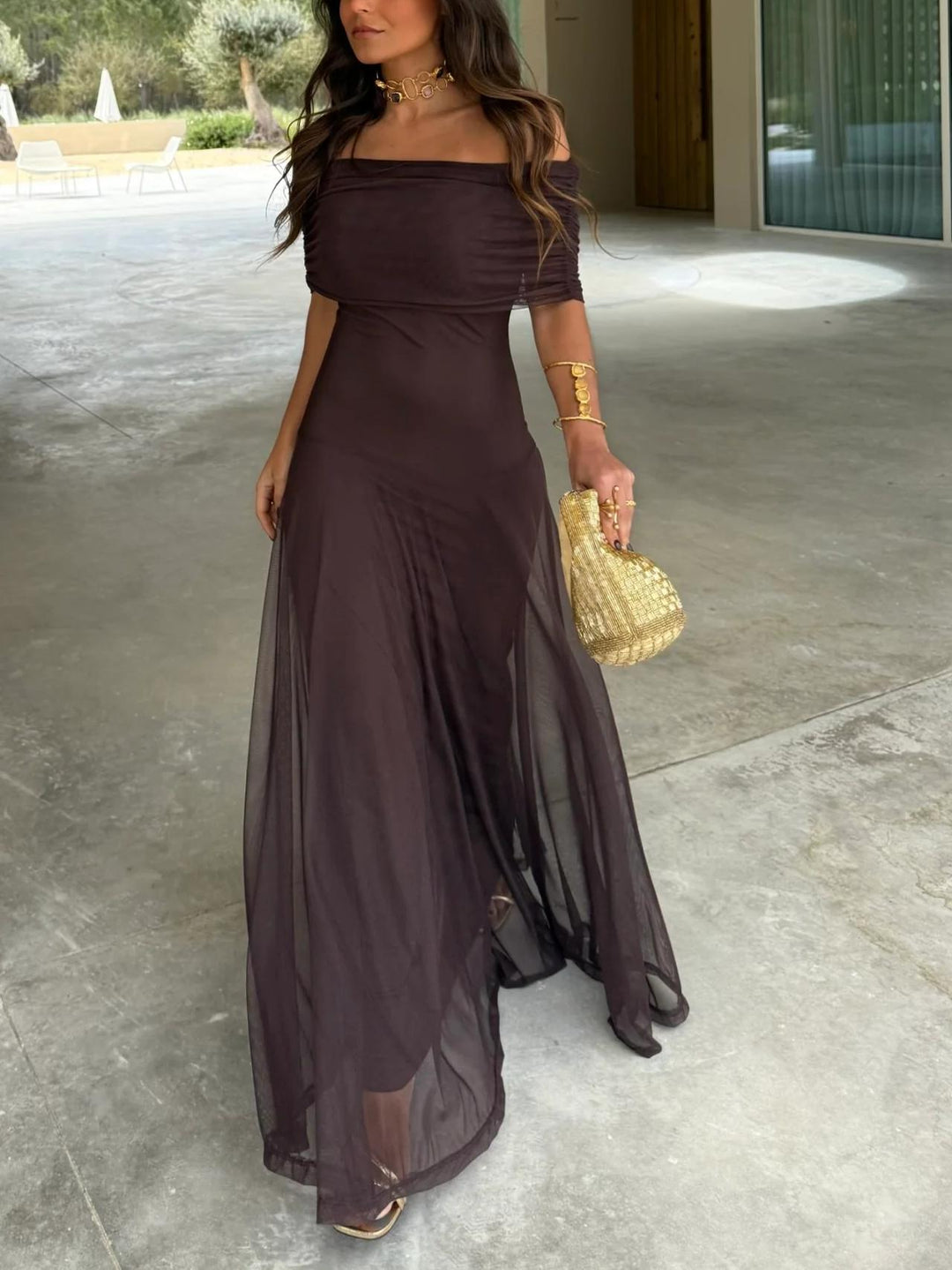 Flowing off-shoulder brown maxi dress with mesh overlay, perfect for wedding guests & evening parties.
