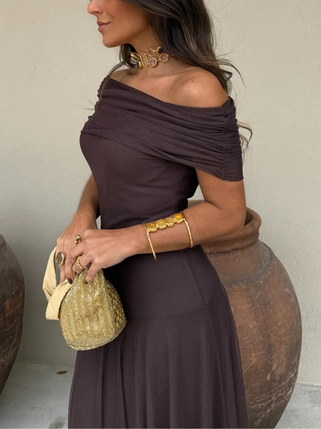 Trendy women's brown off-shoulder maxi dress with mesh overlay, perfect for a chic wedding guest look.