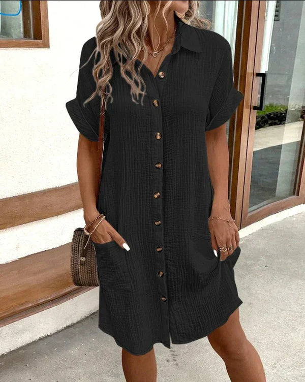 Woman in a relaxed-fit button-front shirt dress, showcasing elegant style for spring & summer day fashion.