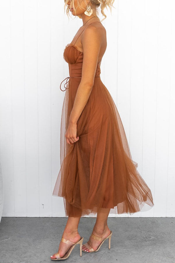 Women's cocktail party midi dress, elegant with a corset top, graceful tulle skirt, and thin straps.