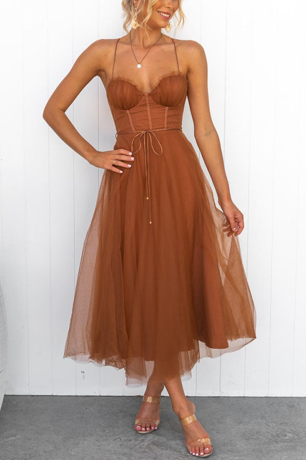 Trendy women's elegant corset midi dress, A-line cut with a delicate tulle skirt and thin straps.