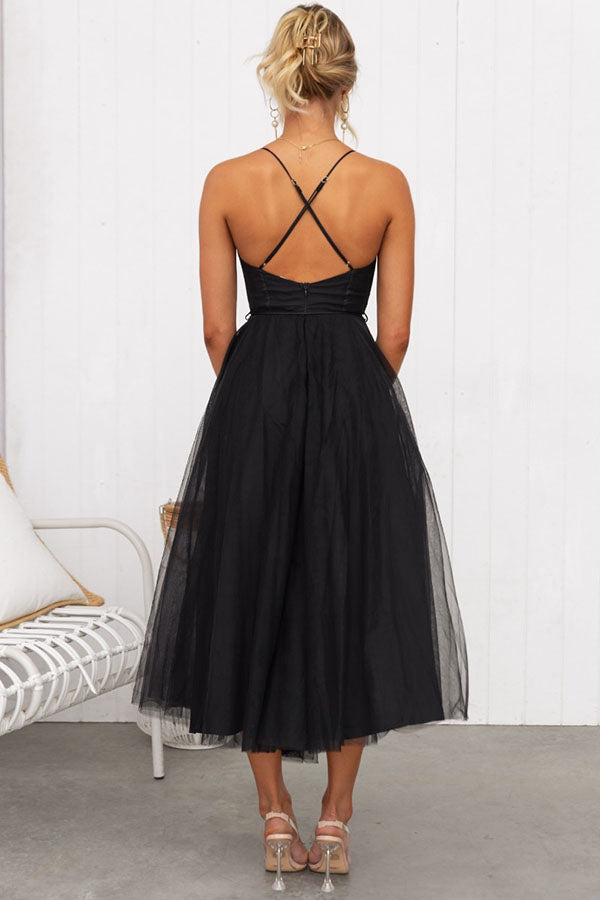 Luxurious elegant women's midi dress with corset design, layered tulle skirt, and thin shoulder straps.