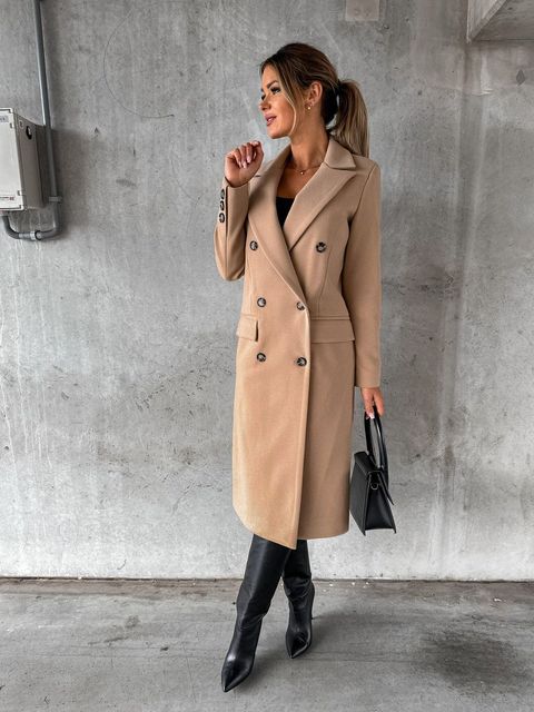 Tailored women's double-breasted winter jacket, offering an elegant outerwear silhouette.
