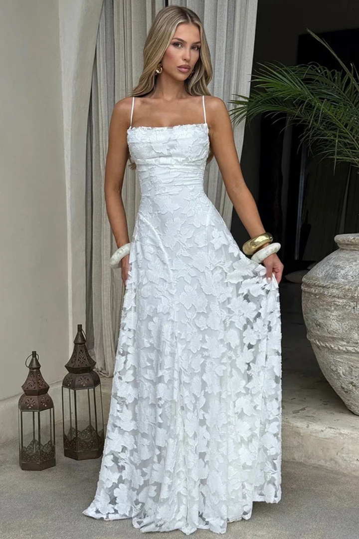 Women's formal floral jacquard maxi dress. Elegant spaghetti strap design with a captivating lace-up back.