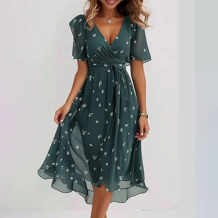 Women's elegant casual floral midi dress, V-neck, flowy skirt & flutter sleeves for warm weather comfort.