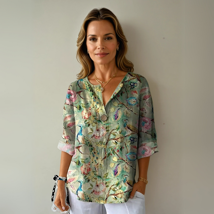 Stylish ladies' 3/4 sleeve button-down blouse with vibrant floral print, a versatile casual top.