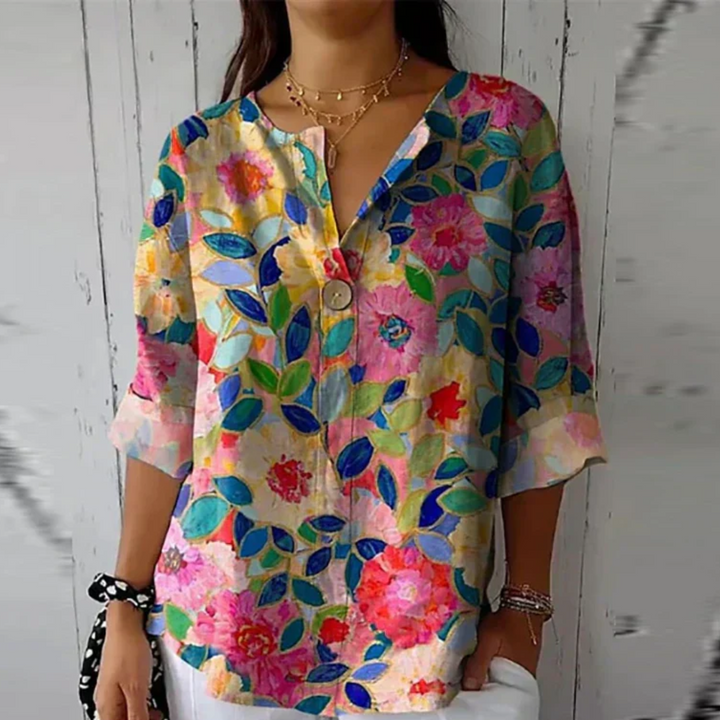 Comfortable button-down floral blouse for women, featuring elegant 3/4 sleeves for casual wear.