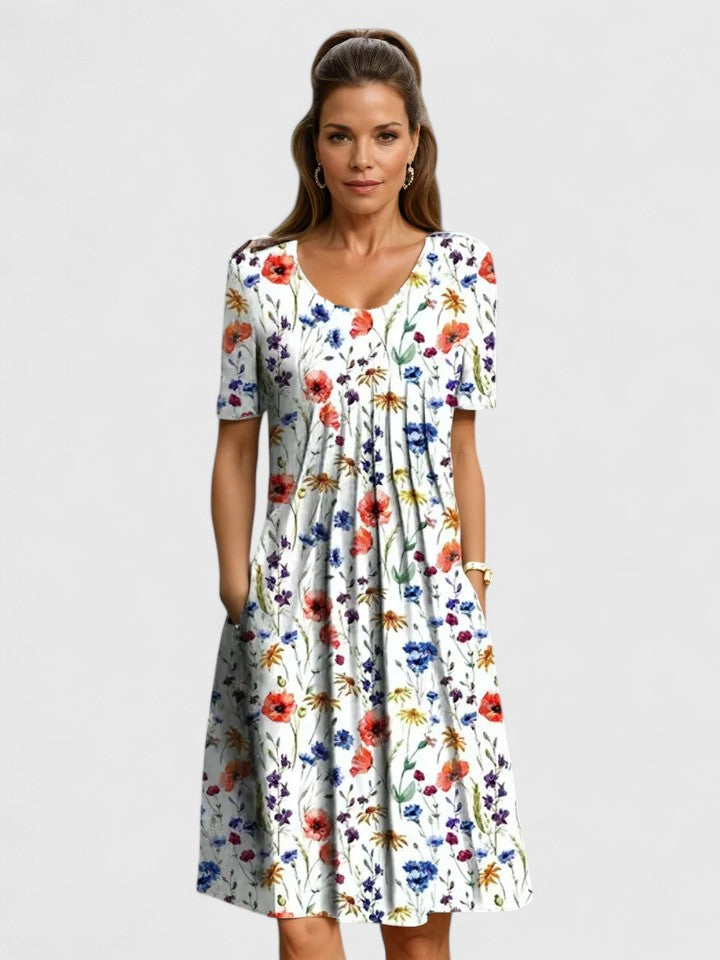 Chic women's short sleeve floral midi dress, perfect for summer. Features a comfortable fit, elegant print, and convenient pockets.