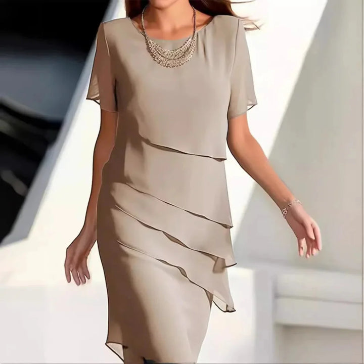 Elegant women's flowy midi dress with short sleeves & round neck, perfect for chic spring & summer style.
