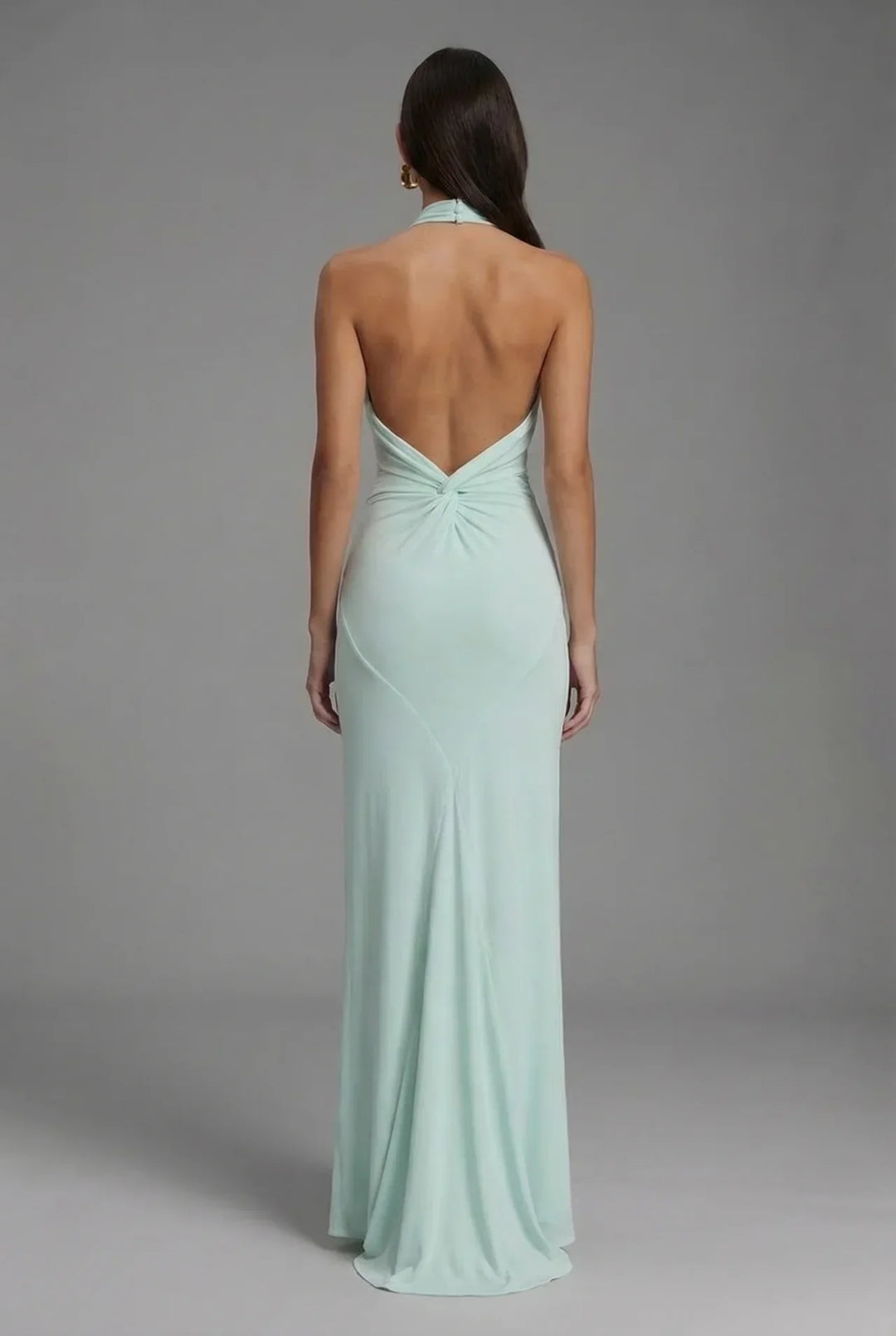 Stunning halter neck backless maxi dress with elegant ruching, ideal for formal occasions and evening events.