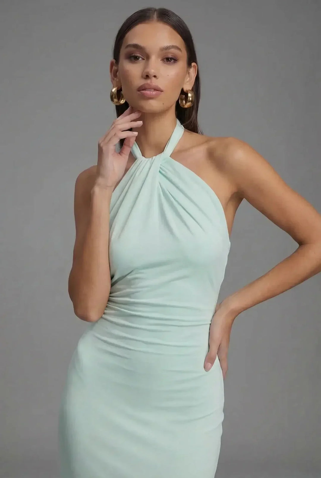 Graceful women's backless ruched maxi dress, featuring a halter neck & flowing silhouette for elegant occasions.