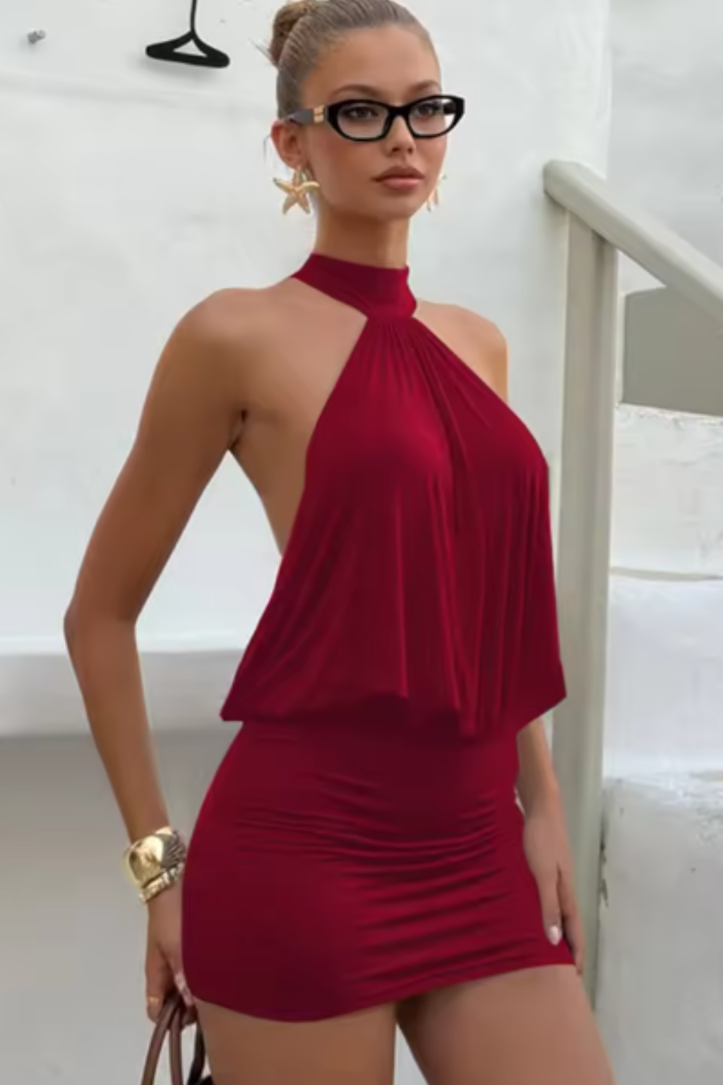Captivating women's mini dress with a graceful halter neck, intricate ruching, and alluring backless cut.