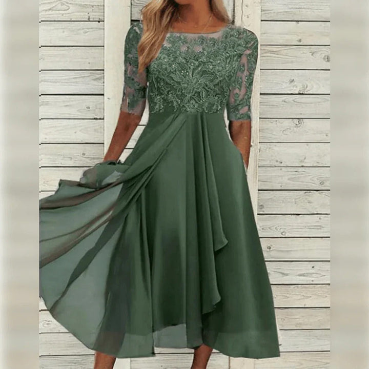 Women's sophisticated lace midi dress, ideal for special occasions. Features a graceful flowing silhouette.