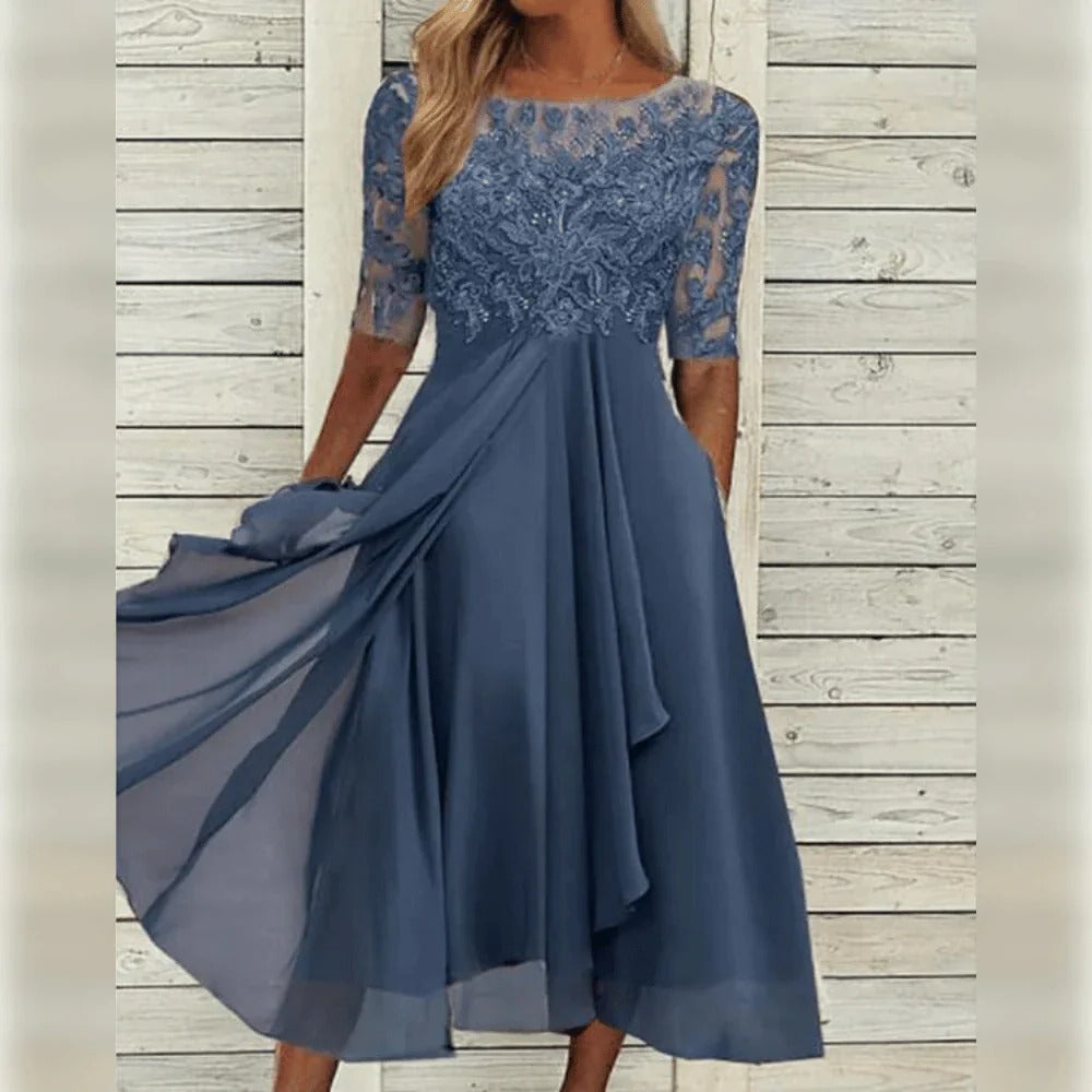 Festive women's midi dress with delicate lace overlay, round neck, and three-quarter sleeves. Elegant formal wear.