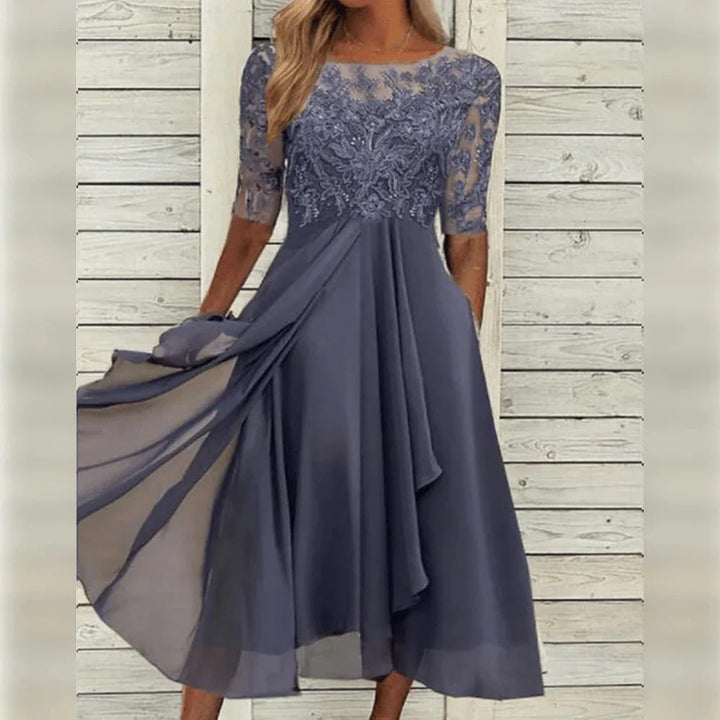 Flowing lace midi dress for women, perfect for elegant parties. Features three-quarter sleeves and round neck.