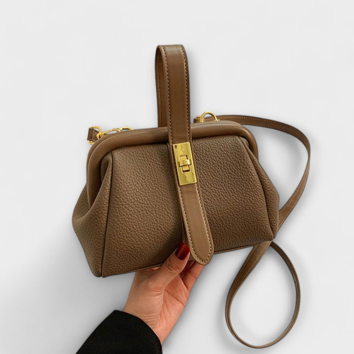 Durable leather mini shoulder bag for women, elegant and practical with a reliable turn lock closure.