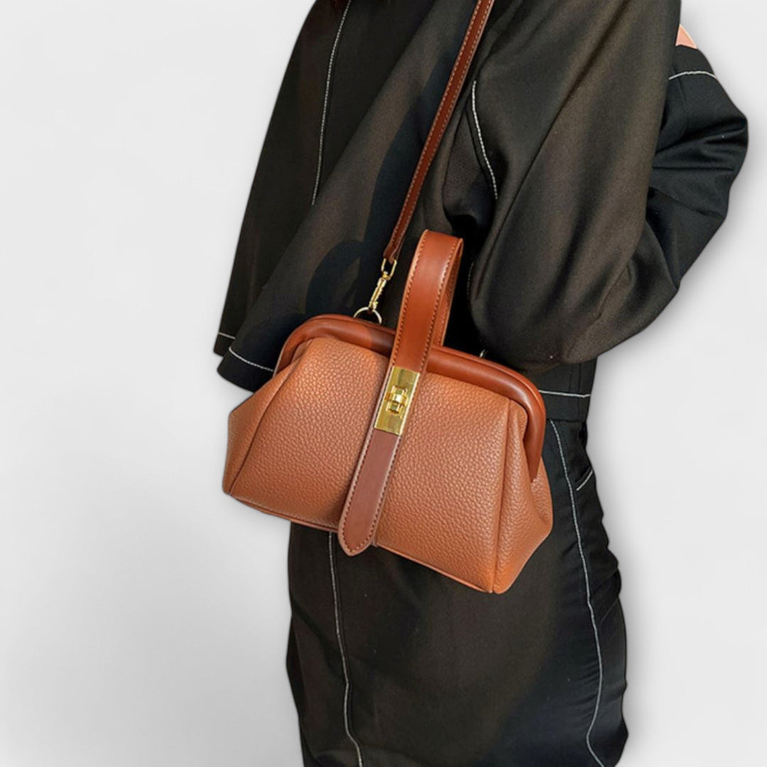 Compact women's elegant leather purse, ideal for essentials, secured with a classic turn lock.