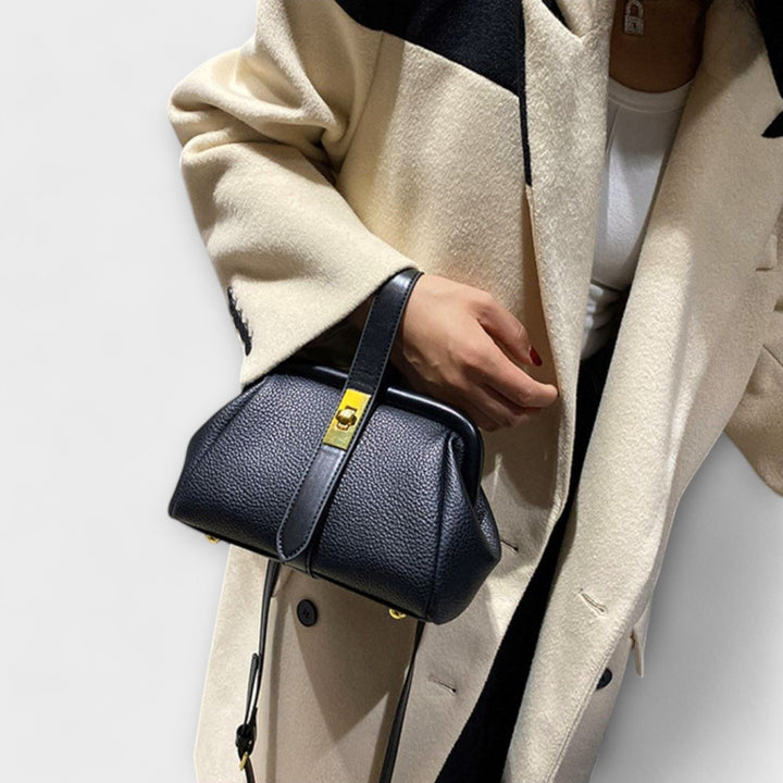 Sophisticated women's leather mini purse, a versatile accessory with an elegant, functional turn lock.