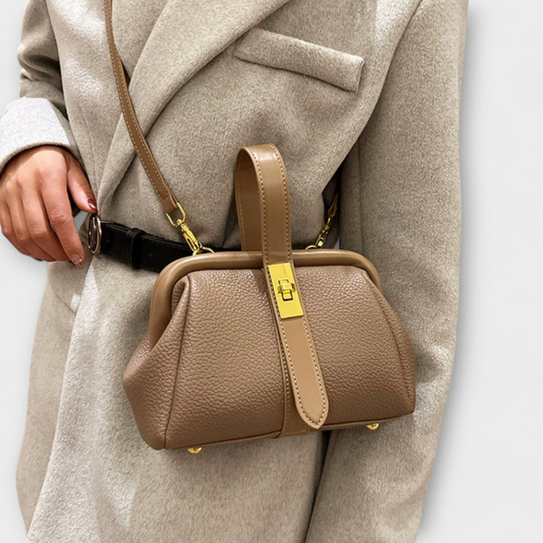 Classic black leather mini handbag with a secure turn lock, designed for the modern elegant woman.