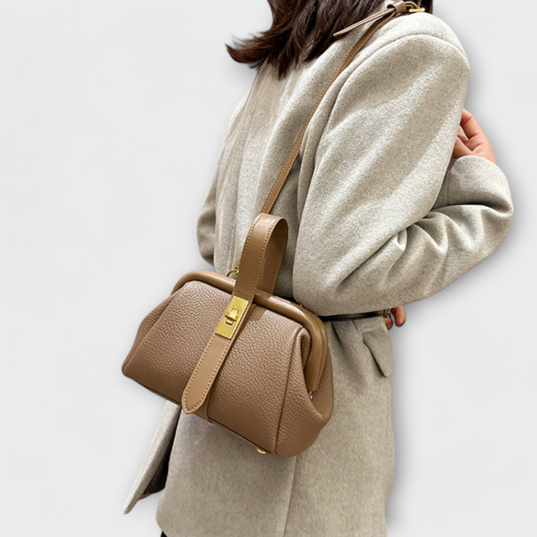 Premium quality leather mini shoulder bag for ladies, showcasing a distinctive, polished turn lock.