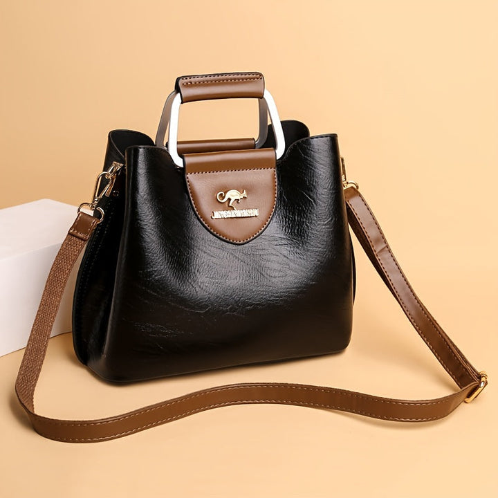 Classic black leather women's handbag, an elegant shoulder bag accessory for daily style.