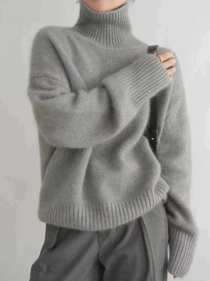 Soft luxe knit women's turtleneck sweater with long sleeves, offering elegant style and comfort.