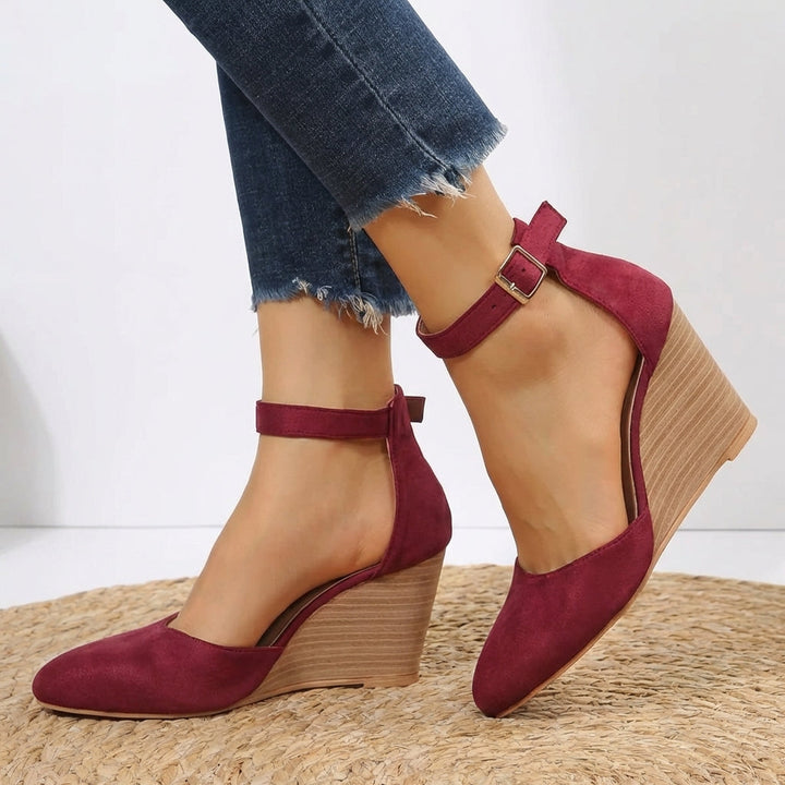 Comfortable women's pointed toe wedge heels featuring a chic ankle strap. Ideal versatile dress shoes for all-day wear.