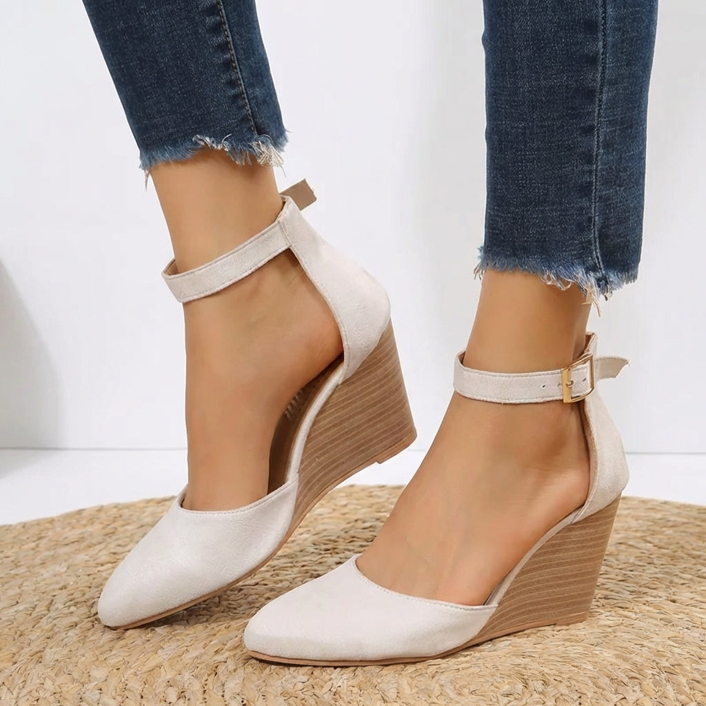 Chic black pointed toe wedge heels for women with sleek ankle strap. Essential comfortable and elegant dress shoes.
