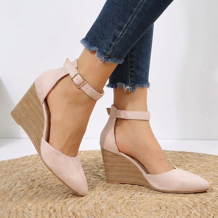 Fashionable women's pointed toe wedge heels with elegant ankle strap detail. Versatile and comfortable footwear for any occasion.